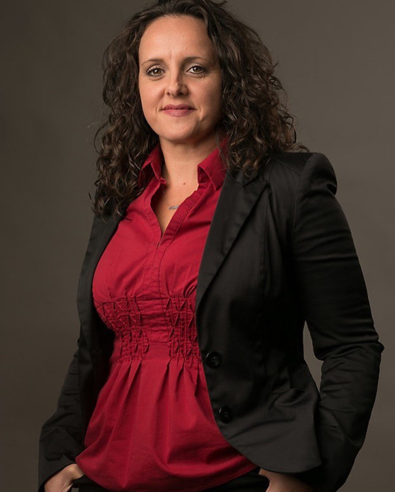 Woman in red shirt and black jacket.