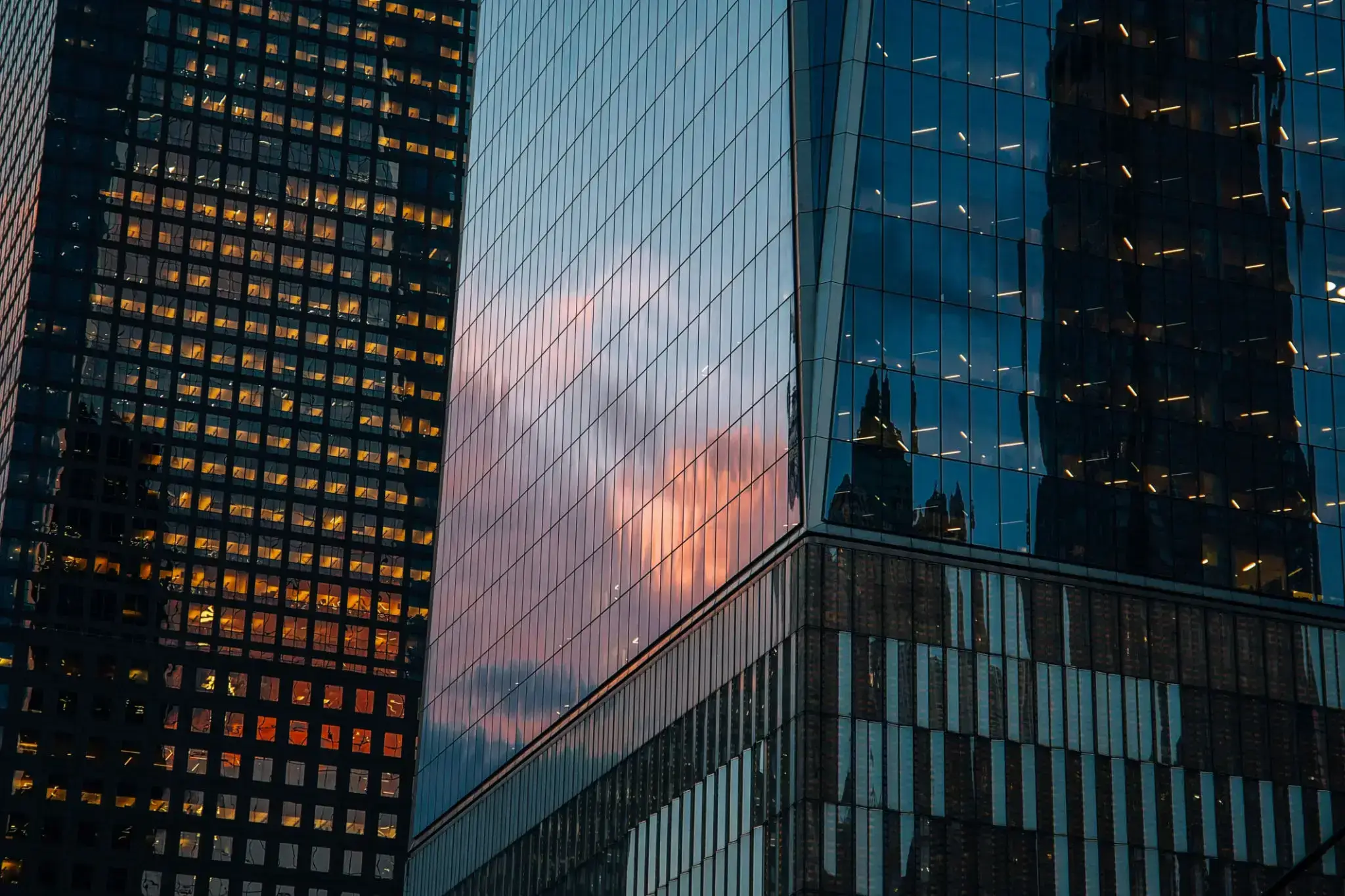 Skyscrapers reflecting clouds during sunset.