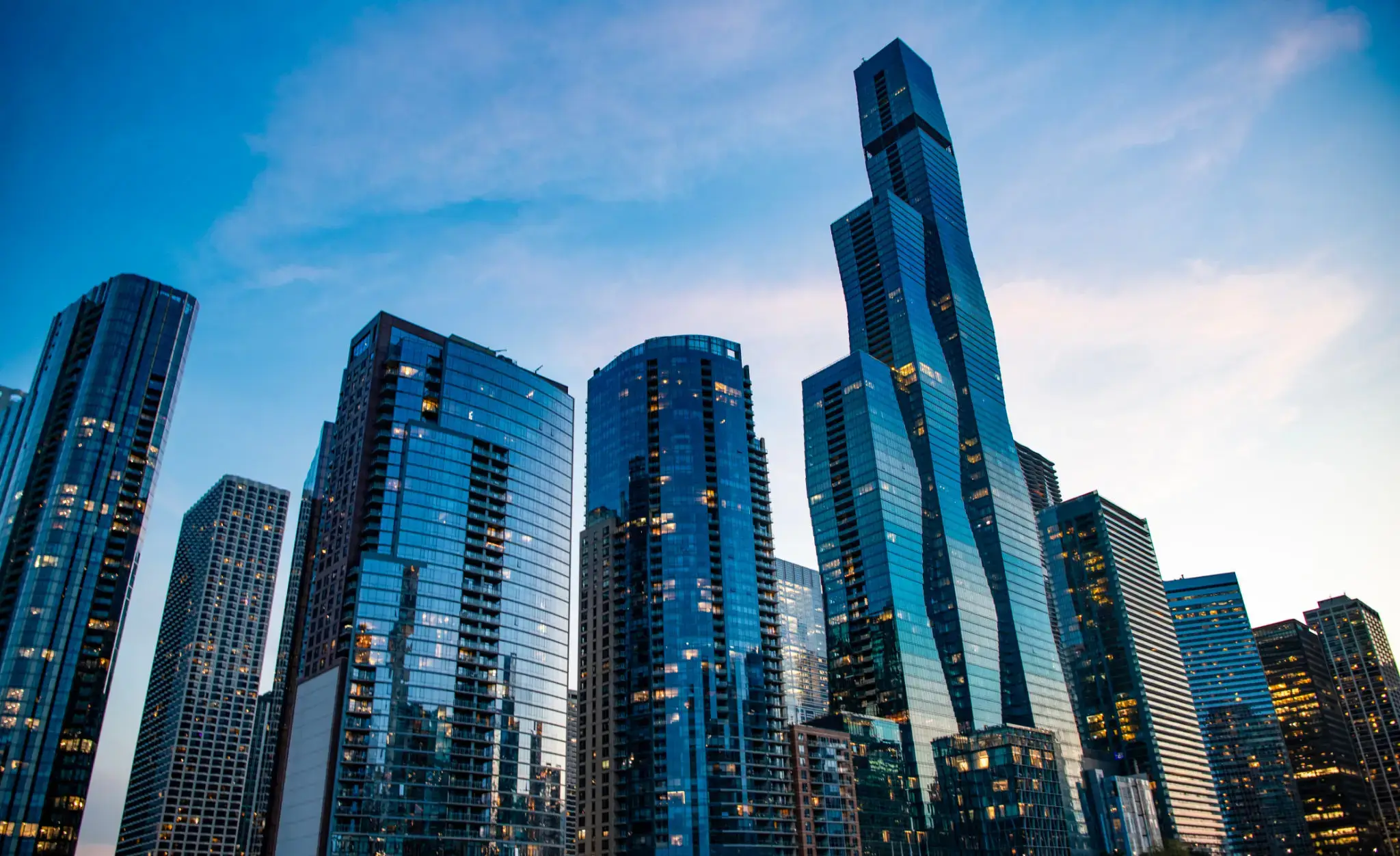 Skyscrapers against a blue sky at dusk.